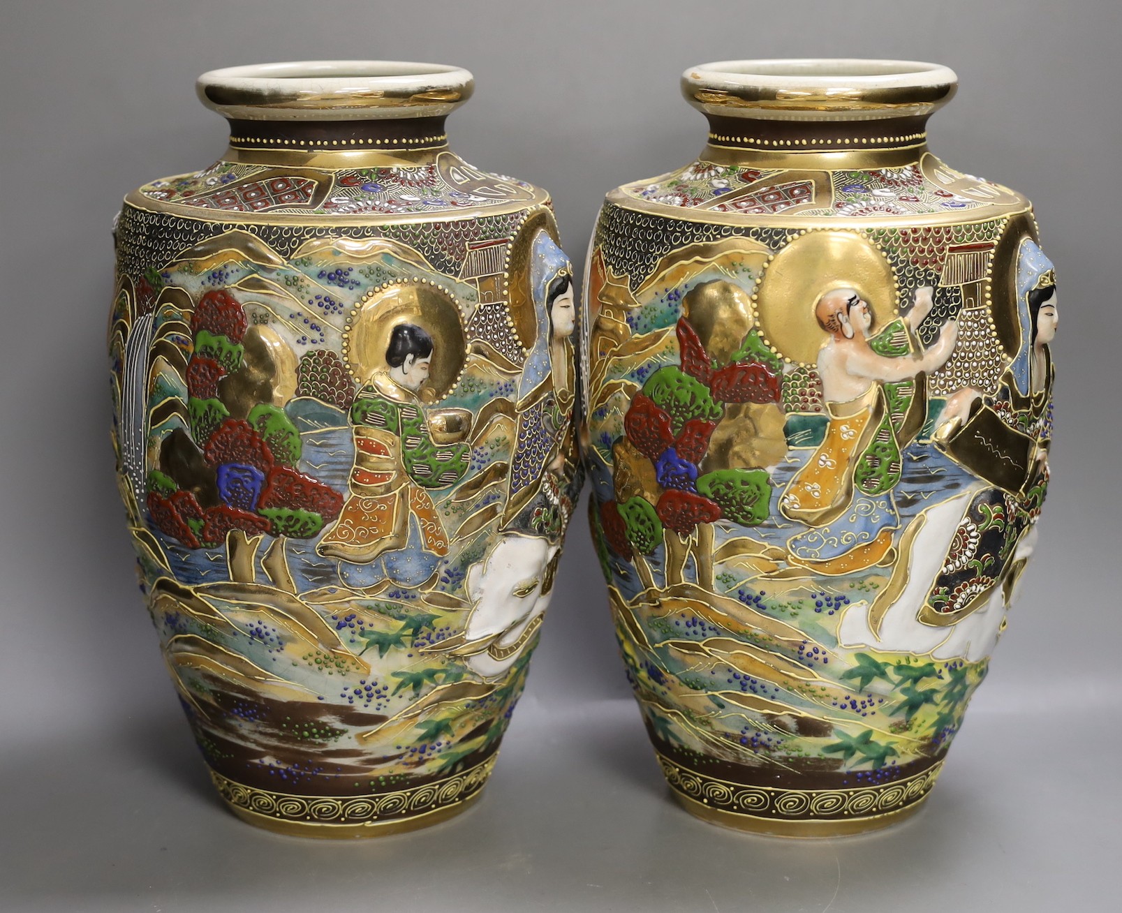 A pair of Japanese moulded and moriage decorated vases, 31cms